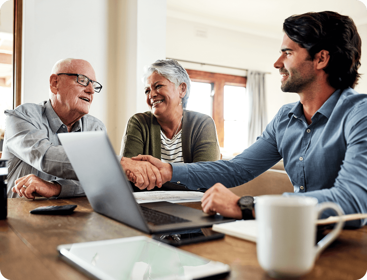 Older couple shaking hands with advisor